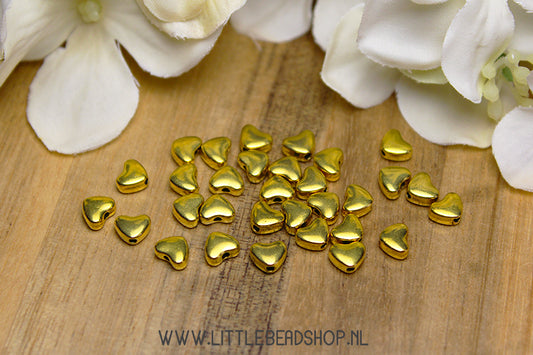 Small gold-colored heart spacer beads, +/- 30 pieces