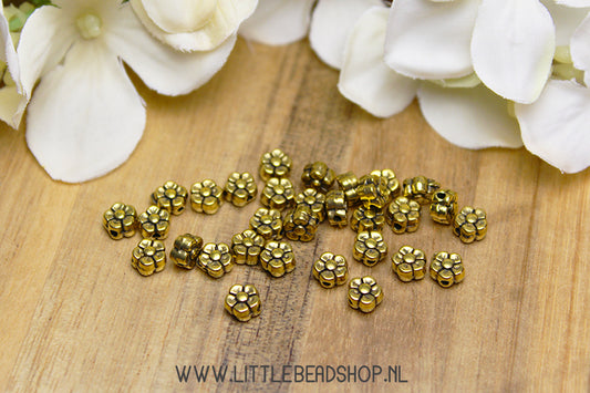 Gold-colored flower spacer beads, +/- 30 pieces