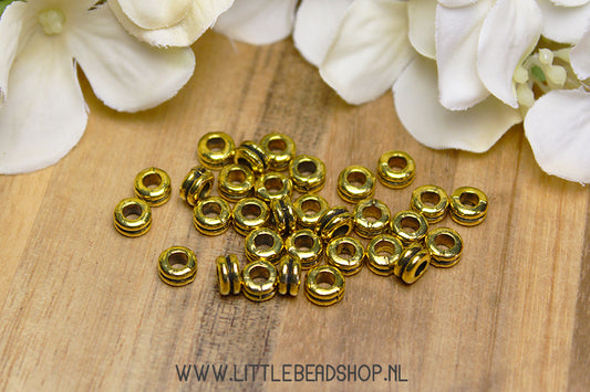 Gold-colored Stripes spacer beads, +/- 30 pieces
